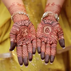 A personalized design for a special occasion. This mehndi includes a one-rupee coin from the bride's birth year and an auspicious swastika symbol.