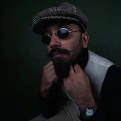 A classic portrait look featuring a flat cap and vest. This demonstrates my versatility for timeless men's fashion, grooming products, and headshot photography.