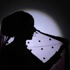 Another take on the bridal silhouette, this time capturing the bride holding her veil. The play of light and shadow creates a dramatic and beautiful image that is both timeless and modern.