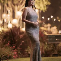 Ready for an evening under the stars. A client looks stunning in a custom champagne-colored gown, fully sequenced for a sparkling effect perfect for a reception or gala.