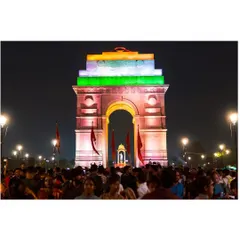 A wide night shot of India Gate, bustling with crowds during a national celebration. This image captures the grand scale and festive energy of public gatherings in Delhi.