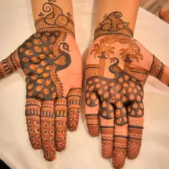 The peacock is a timeless motif in mehendi art. Here, I've used negative space to make the peacocks pop, with one design featuring a single large bird and the other showing a peacock under a tree.