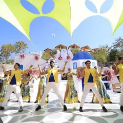 We transformed a venue into a slice of Greece for this 'Around the World' carnival theme. Our team designed the entire experience, from the Santorini-inspired set to the coordinated dancers, making the couple's entry a vibrant, sun-soaked celebration.