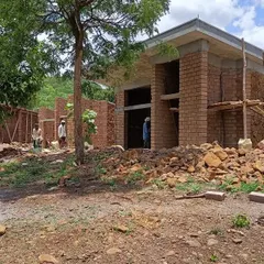 The Gamaya villas under construction, with walls of exposed brick and local stone. The building is nestled among existing trees, which we always strive to preserve as part of the site's natural heritage.