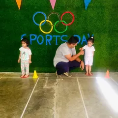 We provide one-on-one encouragement to even our youngest members. Here, we're guiding a toddler through a sports day activity, helping her build confidence from an early age.