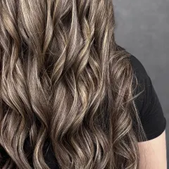 A close-up on the curls, showcasing the beautiful ribbons of blonde woven through the darker base color.