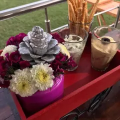 A simple yet elegant appetizer tray. This small red cart holding breadsticks and dips is a creative way we serve food, adding a playful element to the presentation.