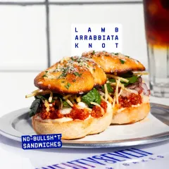 My sandwiches are anything but boring. This is the Lamb Arrabbiata Knot, packed with spicy lamb, whipped garlic yogurt, and fresh mint salad, all stuffed into our signature garlic knots. It's a full-on flavour experience.