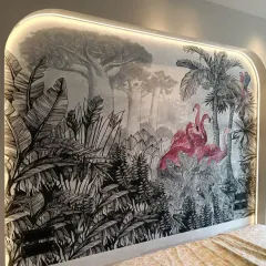 We brought a tropical retreat indoors with this custom bedroom wallpaper. The design features a dramatic, hand-drawn jungle scene in monochrome, with vibrant pink flamingos creating a stunning pop of color. The arched headboard with custom lighting makes it a true centerpiece.