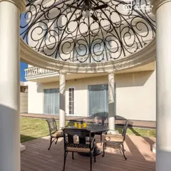 This intricate gazebo at 'The Ivory Royale' residence in Jalandhar is a testament to our dedication to craftsmanship. The ornate metalwork dome and classical columns create an elegant outdoor seating area, perfect for enjoying the surrounding gardens. This project was proudly featured in The Architect's Diary.