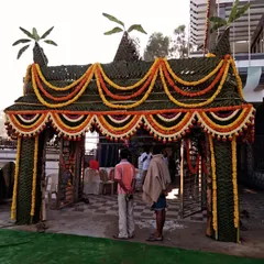 For a truly authentic housewarming, I design and build traditional *chappra* entrances. This grand entrance is woven entirely from fresh coconut leaves and decorated with beautiful garlands of marigold flowers, creating a spectacular and auspicious welcome for your guests.