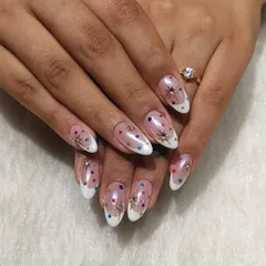 A fun and festive look perfect for Navratri or any celebration. These nails feature a modern French tip base with colorful polka dots and sparkling star charms for a playful touch.