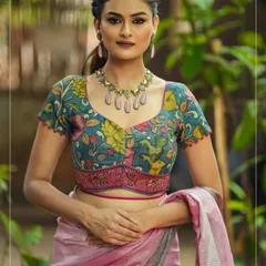 This is one of my signature Pen Kalamkari blouses. The intricate floral and bird motifs are hand-painted, and the unique cut of the blouse makes it a contemporary piece of wearable art. It’s shown here paired with a simple linen saree to let the blouse shine.