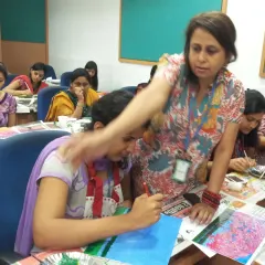 I believe in guiding every student personally, no matter the size of the group. Here at a Wipro workshop, I am helping a participant find her flow. My role is to be a gentle guide, ensuring everyone feels supported and leaves with a smile and a masterpiece.