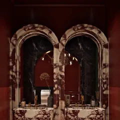 The ladies' washroom at Koko Hyderabad is all about drama. We used a stunning red and white marble to create custom arched vanities that serve as the centerpiece of the room.