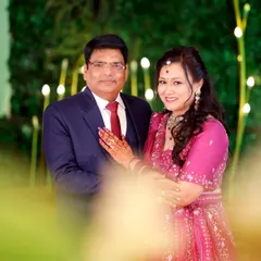 A beautifully framed portrait of the anniversary couple, using a soft foreground blur to create a sense of intimacy and focus.