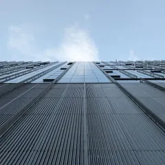 A dramatic upward shot of the facade at the Godrej Koregaon Park campus. The image captures the immense scale and clean, modern lines of this 1.9 million sq. ft. corporate development in Pune.