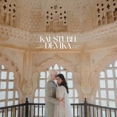 An intimate embrace within the intricate latticework of a Jaipur palace. The soft light filters through the jharokha, creating a serene and romantic portrait that feels both timeless and personal.