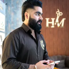 A showcase of our expert men's grooming. This style features a high-volume quiff, a sharp fade, and a perfectly maintained beard.
