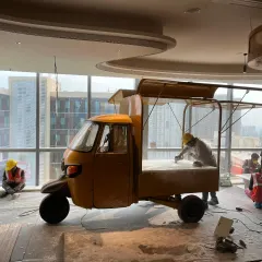 The project begins on site. Here, our team is prepping the auto-rickshaw inside the office space, getting the surface ready for the intricate hand painting and structural modifications to come.