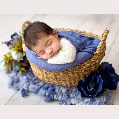 I just can't get over the sweetness of this little one. Safely posed and sleeping so peacefully in a rustic woven basket, this classic newborn portrait captures those precious, fleeting moments with a beautiful blue color palette.