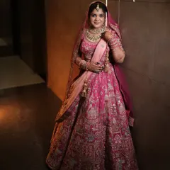 This bride looks absolutely regal in her pink lehenga. The makeup is soft and glowing, with a focus on enhancing her natural features.