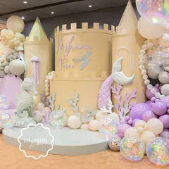 I designed an enchanting underwater kingdom for Mihana's mermaid-themed birthday. This magnificent castle backdrop, adorned with pastel balloon bubbles and iridescent details, was the centerpiece of a truly magical deep-sea adventure.
