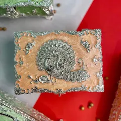 The same exquisite peacock design, this time on a warm peach enamel box. The soft pastel shades of this collection offer a blend of utility and elegance for your home.