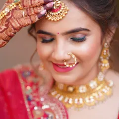 A close-up on the eyes. A pop of teal liner adds an unexpected and modern twist to the traditional red lehenga look.