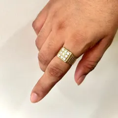 A different perspective of the square-faced diamond ring, this view highlights the texture on the band and the brilliance of the nine diamonds as they catch the light. It shows the ring's commanding presence on the hand.