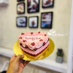 A heart-shaped vintage cake for a 26th birthday. The delicate piping and simple floral details give it a timeless and romantic feel.