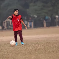 A player looks for an opportunity on the field. We create a positive environment where kids feel confident to dribble, pass, and shoot, all while having fun with their friends.