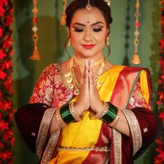 A festive look for Ganesh Chaturthi. This client is wearing a yellow and red Nauvari, perfectly draped for a day of celebration and prayer. The drape allows for easy movement and sitting.