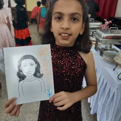 The birthday girl is thrilled with her caricature drawing. It's a fun activity that captures the likeness of the guests in a playful, artistic style.