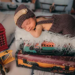 Ready for a lifetime of adventure. This 11-day-old baby boy is sleeping so soundly on a stack of vintage suitcases, dreaming of all the places he'll go.