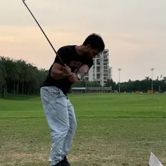 A snapshot of a powerful follow-through in a golf swing. This explosive movement is the result of developing rotational power and lower body stability through targeted strength and conditioning.