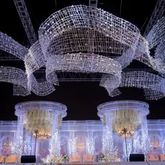 A view from below the custom-fabricated overhead installation. These massive, woven structures were designed to look like flowing ribbons of crystal, adding a sense of movement and grandeur to the night sky.