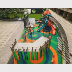 This view shows the variety of play equipment integrated into the landscape, including slides, spinners, and climbing structures, all within a cohesive design.
