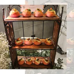 Bite sized Pav Bhaji served in pink buns, displayed on a rustic wooden stand. This creative twist on a beloved classic adds a pop of color and fun to any event menu.