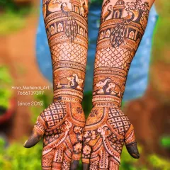 A traditional Rajasthani-style bridal mehendi featuring majestic elephants and palace architecture (jharokhas) on the forearms, with graceful peacocks on the palms.