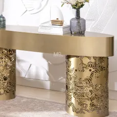 This is where metal meets art. The Ferrosa Console is sculpted from high-grade metal with a brushed antique gold finish. The base features intricate laser-cut carvings inspired by traditional Jaali work, reimagined in a contemporary form. It’s a piece that balances opulence with modern restraint, perfect for an elegant entryway.