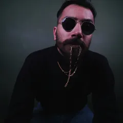 A close-up from a recent studio session, focusing on a moody, high-contrast look. This style is great for classic men's fashion editorials and accessory features, like sunglasses or chains.