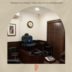 Every detail in the salon is considered, right down to the styling stations. This image shows a private grooming station with a classic leather barber chair, wood paneling, and pinstripe wallpaper, creating a space that feels both professional and comfortable.