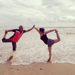 Yoga is a family affair for us. Here I am practicing a partner Natarajasana (Dancer's Pose) with my daughter on the beach. We teach together, bringing our combined experience and a supportive family feel to every class.