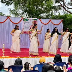 A group of ladies performing a simple, elegant routine on stage for an Onam celebration. My choreography is suitable for family functions and cultural events where all generations participate.