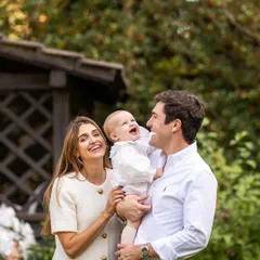 Pure, unscripted laughter. I captured this beautiful family portrait in just a few minutes after their baby's baptism, proving that the best moments are often the most spontaneous.