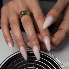 A stunning set of long, milky-nude stiletto nails. The color is soft and understated, while the shape adds drama.