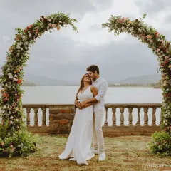 A beautiful pre-wedding portrait session by the lake, framed by a stunning floral arch. I love creating these grand, scenic shots that feel like a fairytale.