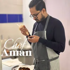 Chef Aman, one of our co-founders, meticulously plating a dish. His attention to detail and passion for flavour is at the core of what we do.