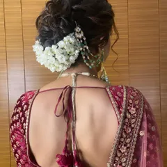 Another angle of this beautiful gajra bun, showing how the white flowers create a lovely contrast against the dark hair and the bride's deep red lehenga.